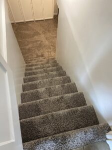 Newly installed or freshly cleaned carpet on a staircase, demonstrating quality work by Utah Carpet Systems in Orem, UT.