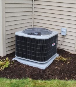 A newly installed outdoor air conditioning unit next to a residential building by Kerley Heating & Cooling in Rock City, IL