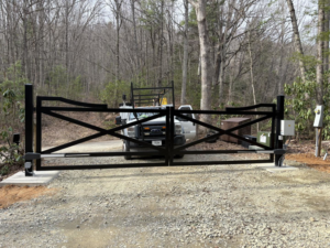 A newly installed black automatic gate with a Gilliam Services LLC work truck in Johnson City, TN.