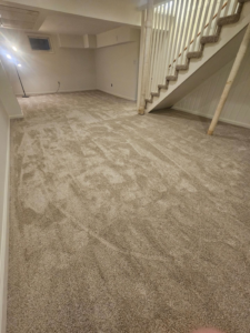 A spacious basement room with newly installed light brown carpet by Carpets Mostly in Indianapolis, IN