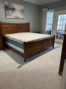 A bedroom featuring newly installed wall-to-wall carpet, a finished project by United Carpet in Rochester, NY.