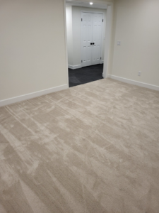 A room featuring newly installed light beige carpet by Christie Carpets & Blinds in Rochester, NY