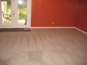 A living room featuring newly installed light beige carpet by Big Orange Country Carpets & Concepts in Knoxville, TN.