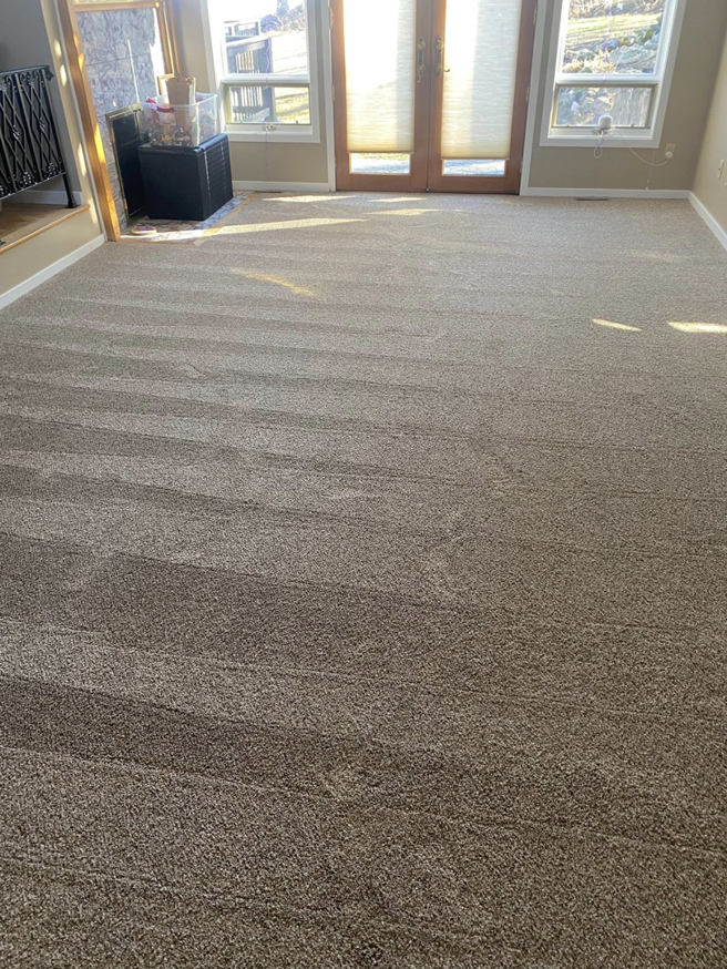 A spacious living room with newly installed beige carpet by Dodson Floorcoverings in Birdsboro, PA