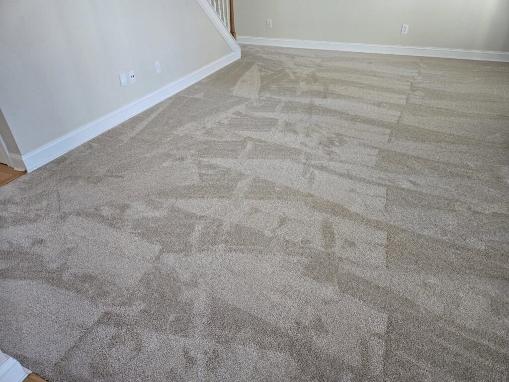 A living room featuring newly installed beige carpet by P&Q Flooring in Johns Creek, GA.