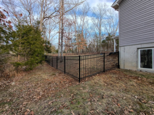 A newly installed black metal fence enclosing a residential backyard by Fence Experts STL in Fenton, MO