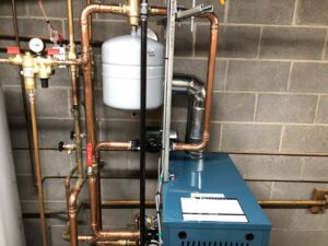 A newly installed boiler system with intricate copper piping and an expansion tank by Ohio City Heating and Cooling in Cleveland, OH.