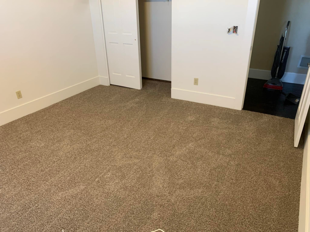 A newly installed brown carpet in a bedroom, showcasing a completed carpet contractor job by Canyon State Flooring in Queen Creek, AZ.
