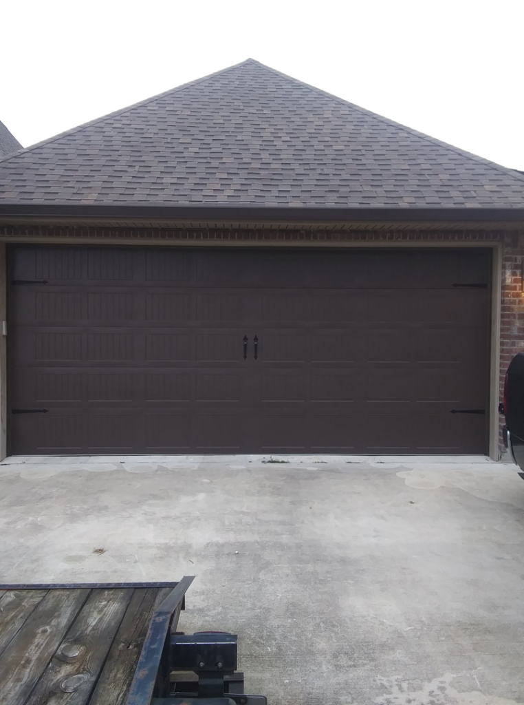 A newly installed brown garage door on a residential home by Residential WorX LLC in Westlake, LA.
