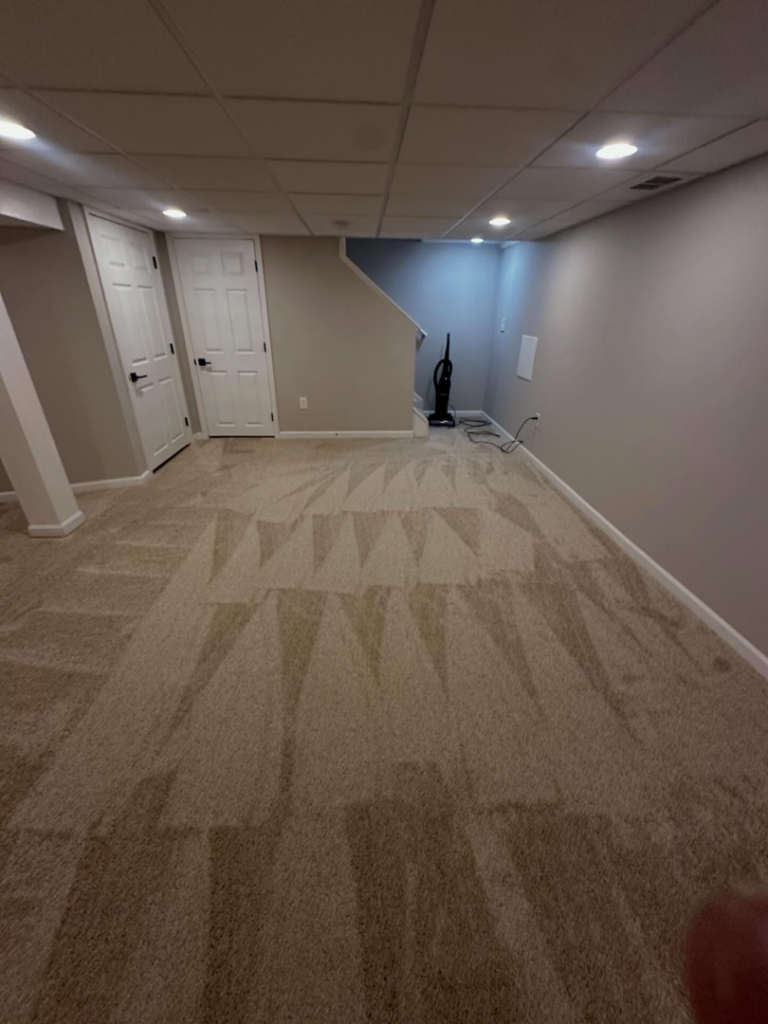 A newly installed carpet with fresh vacuum marks in a finished basement room by Ordonez Flooring and Installation in Lewis Center, OH.