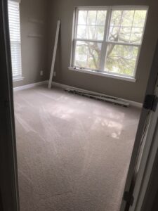 A newly installed light brown carpet in a bedroom, ready for finishing touches by One Stop Contracting in Goose Creek, SC.