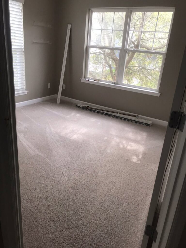 A newly installed light brown carpet in a bedroom, ready for finishing touches by One Stop Contracting in Goose Creek, SC.