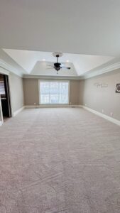 A spacious bedroom featuring newly installed light-colored carpet by Ordonez Flooring and Installation in Lewis Center, OH.