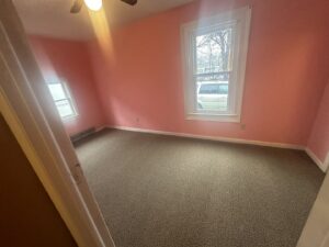 Newly installed brown carpet in a residential bedroom by WCW Carpet Warehouse in Bennington, VT
