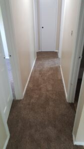 Newly installed brown carpet in a residential hallway by Augusta Carpet Mart in Augusta, GA.