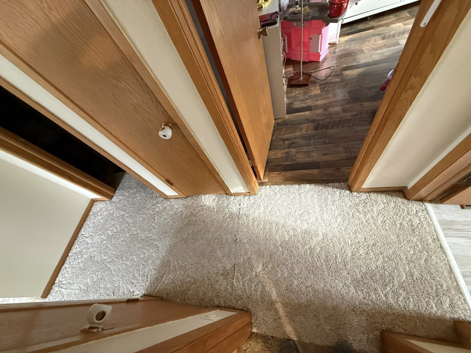 A newly installed, light-colored carpeted hallway by B.A.M Vinyl Flooring LLC in St Charles, MN