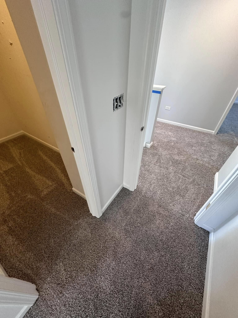 Newly installed carpet in a hallway and room by J&A Flooring Masters Corp. in Joliet, IL.