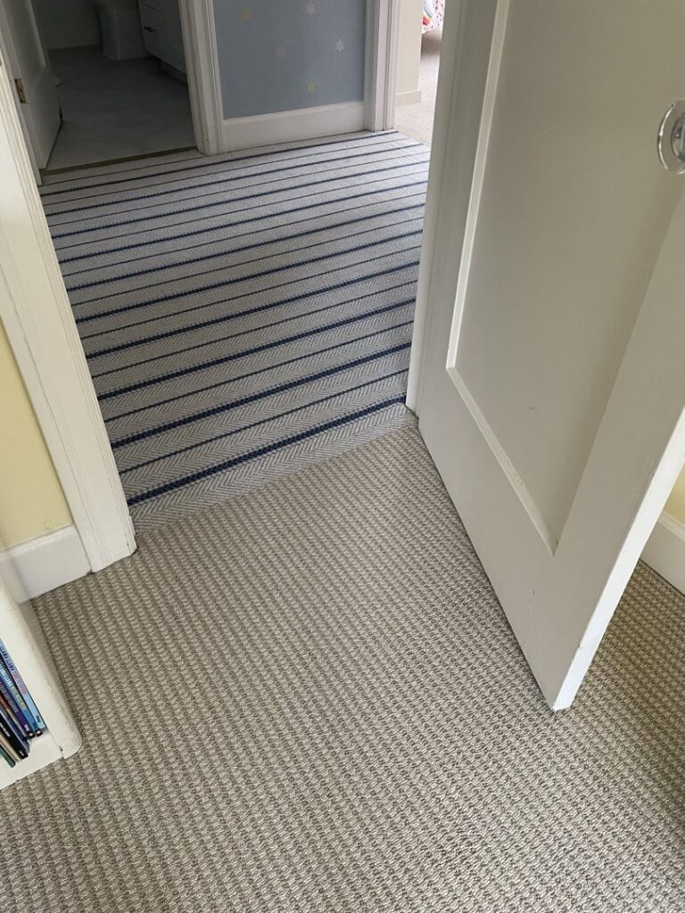 Newly installed carpet in a residential hallway and room entrance by Straus Carpets in Oakland, CA.