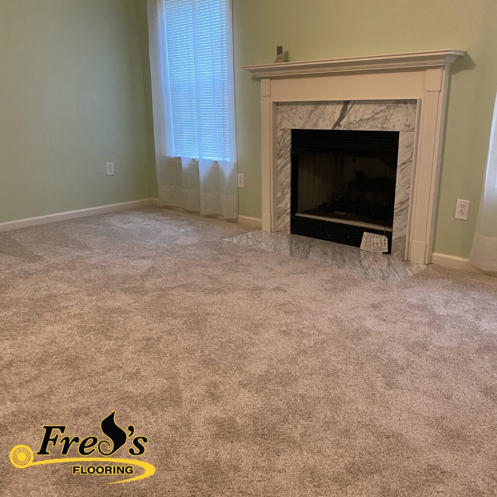 A newly installed carpet in a living room with a fireplace by Fred's Flooring in Murfreesboro, TN.
