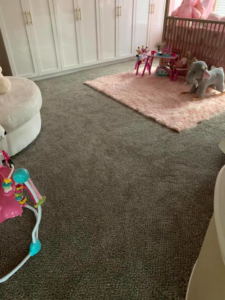A newly installed gray carpet in a child's nursery, showcasing work by Topline Flooring in Houston, TX.