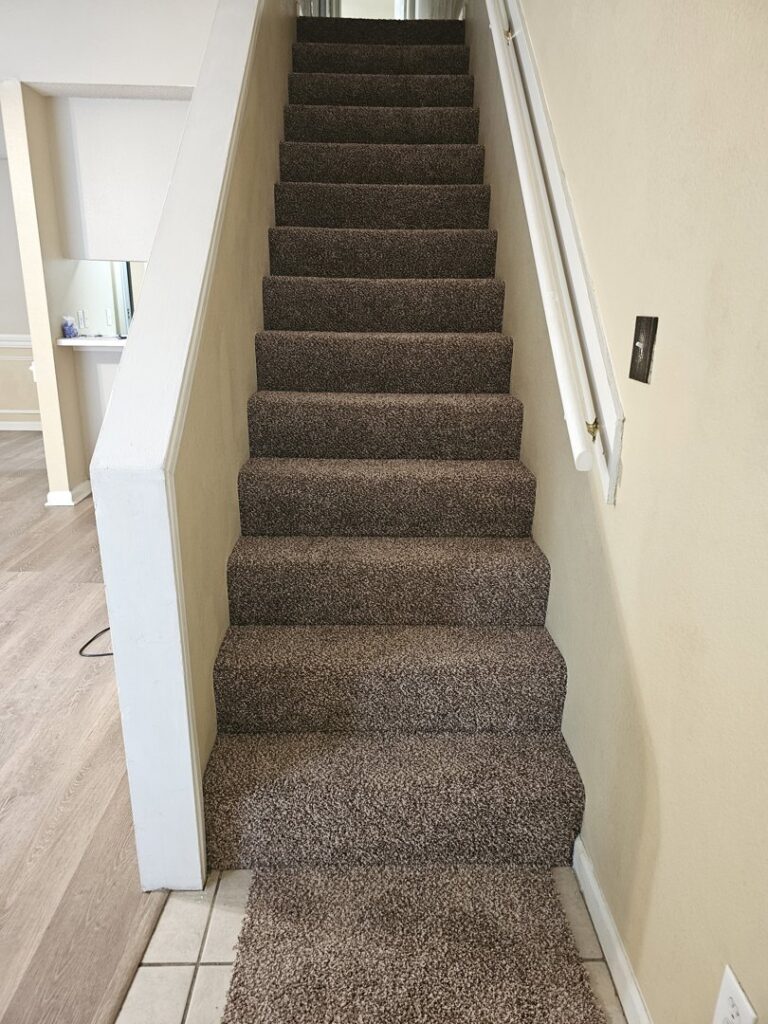 Newly installed brown carpet on a residential staircase by Georgia Floors Direct in Tallahassee, FL