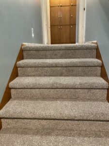 Newly installed light brown carpet on a wooden staircase by Carpet USA in Vancouver, WA.