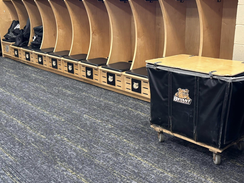 Newly installed grey and yellow carpet tiles in a locker room by Branch Floor Covering in Cranston, RI