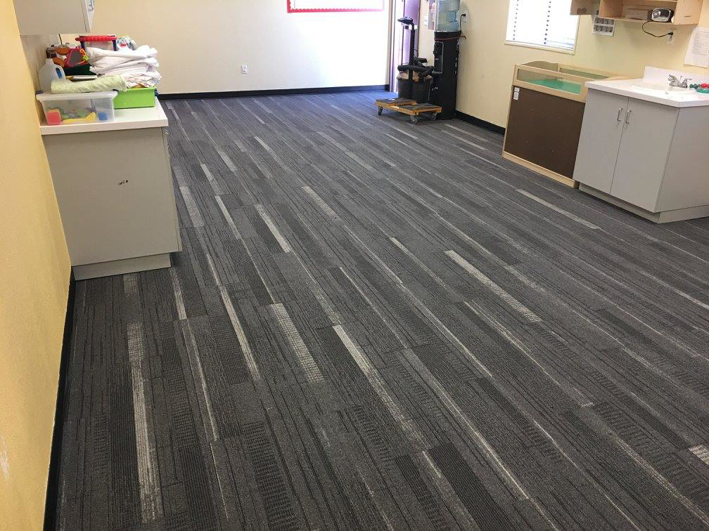 Newly installed carpet tiles with a modern gray and white striped pattern by ReSource Arizona in Phoenix, AZ