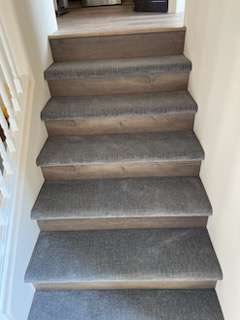 Newly installed carpeted stairs by Jungle Jim's Floorcovering, a carpet contractor in Anchorage, AK.