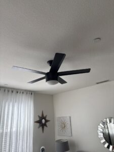 A newly installed black ceiling fan with an integrated light, completed by Steve Cavenee Electric in Orange, CA.