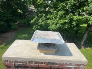 A newly installed chimney cap on a brick chimney by Royal Chimney's in Blue Ash, OH.