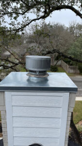 A newly installed chimney cap and siding on a residential chimney by The Texan Chimney Sweep San Antonio, TX.