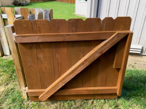 A close-up of a newly installed dark brown wood fence gate by Axiom Fence LLC in Springfield, MO.