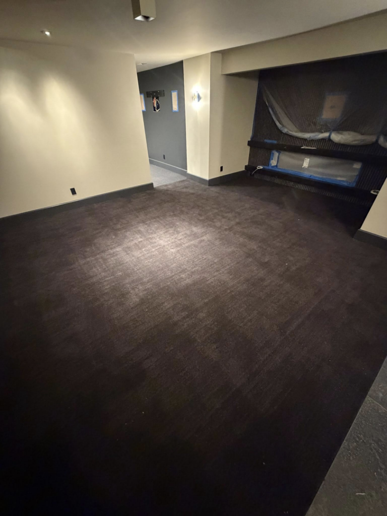 A room featuring newly installed dark carpet by Good Guy Flooring, a carpet contractor in Kansas City, MO