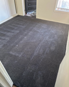 Newly installed dark gray carpet in a room by Jimenez Carpet in Lynwood, CA