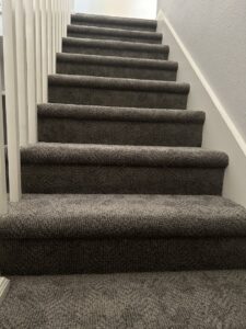 A newly installed dark gray carpet staircase by Vision Flooring in a home in Chandler, AZ.