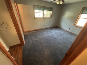A bedroom with newly installed dark grey carpet by Carpet Depot Okc in Oklahoma City, OK.