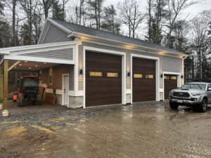 Newly installed exterior lighting on a garage, showcasing electrical work by Russell Electric LLC in Saint Clair, MI