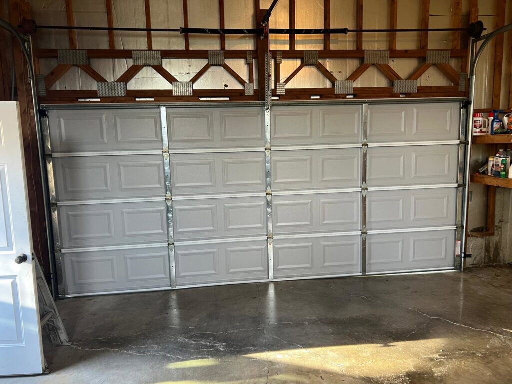 A newly installed garage door from the interior, showcasing quality work by Lenny's Garage Door in Louisville, KY.