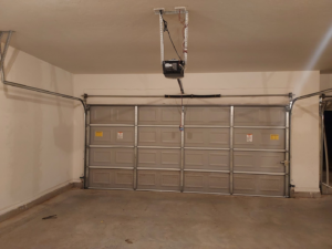 A newly installed garage door with an automatic opener system by Zee's Garage Doors in Oklahoma City, OK.