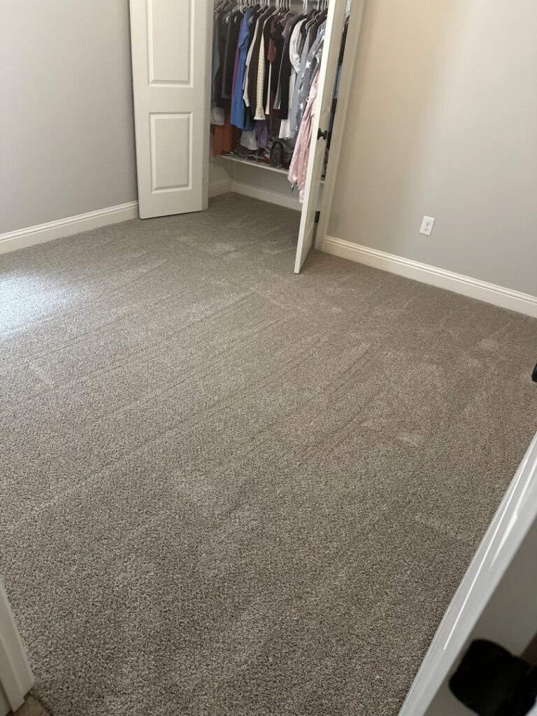 A bedroom showcasing newly installed gray carpet by Carpet World Baton Rouge, LA.