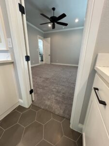 A newly installed gray carpet in a bedroom by Texas Tuff Floors in Dallas, TX