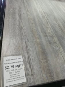 Newly installed gray carpet in a residential bedroom with teal walls by Wholesale Carpet of Sumter in Sumter, SC.