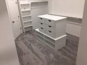 A spacious closet with newly installed light gray carpet by All Dimension Floor Care in Lenexa, KS.