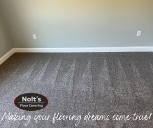 A newly installed gray carpet with visible vacuum lines, showcasing a finished carpet contractor job by Nolt's Floor Covering in Ephrata, PA.