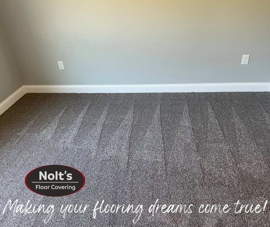 A newly installed gray carpet with visible vacuum lines, showcasing a finished carpet contractor job by Nolt's Floor Covering in Ephrata, PA.