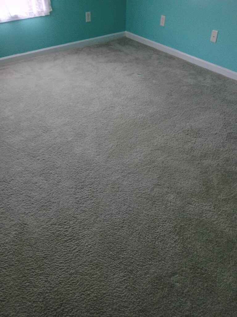 Newly installed gray carpet in a residential room by Wholesale Carpet of Sumter in Sumter, SC.