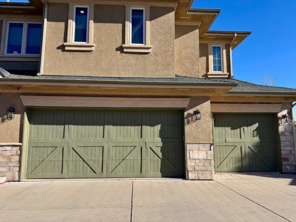 Two newly installed green garage doors by Advanced Door Works in Highlands Ranch, CO