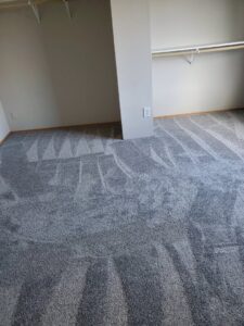 Newly installed grey carpet with vacuum lines in a bedroom by Columbia Flooring Group in Troutdale, OR