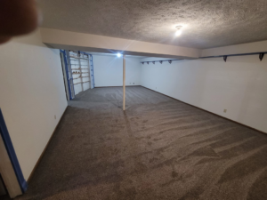 A large basement room with newly installed grey carpet by Washington Family Flooring LLC in Bellevue, NE.